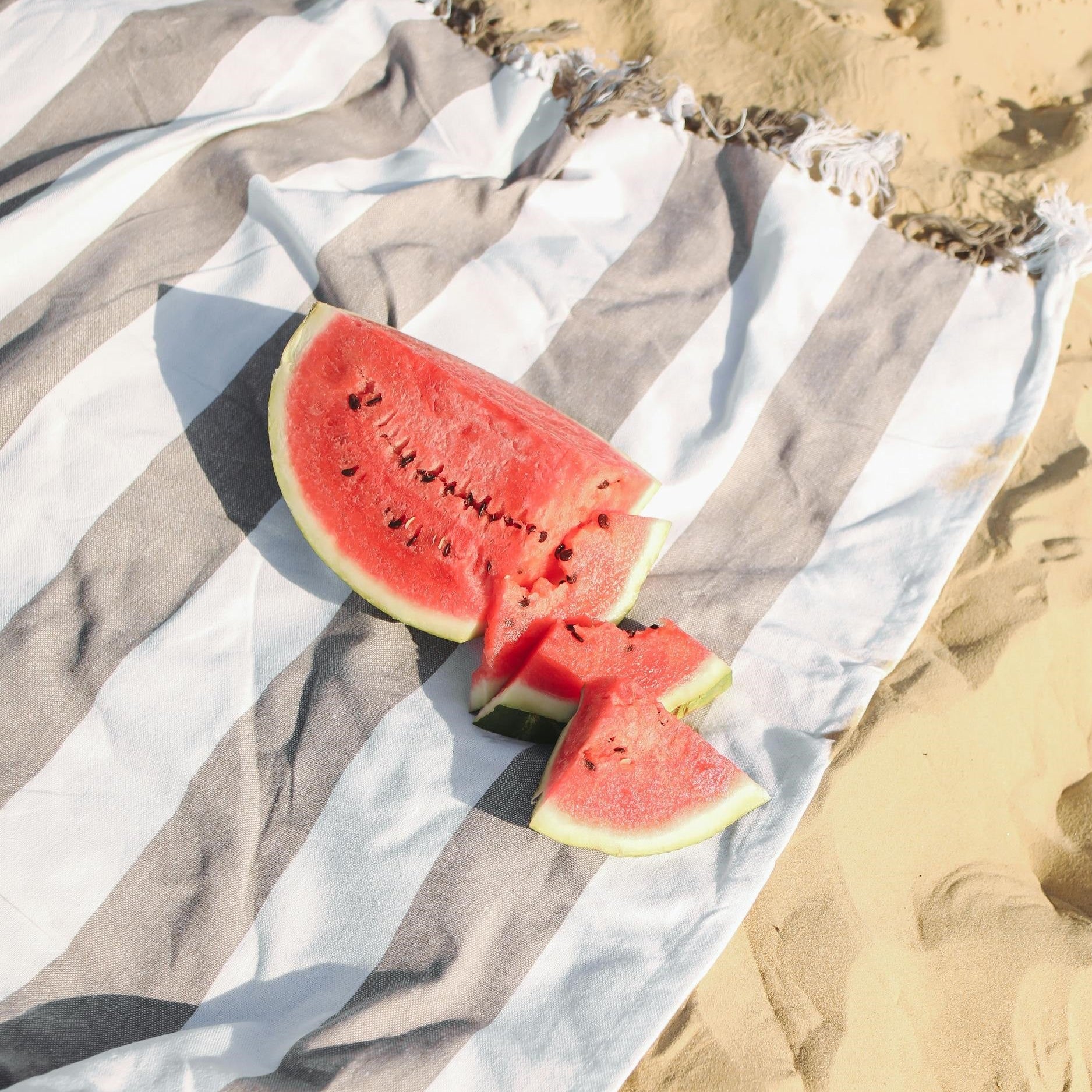A fresh watermelon cut open, representing the health benefits of consuming seasonal produce, supporting local farmers, and reducing environmental impact through mindful food choices.