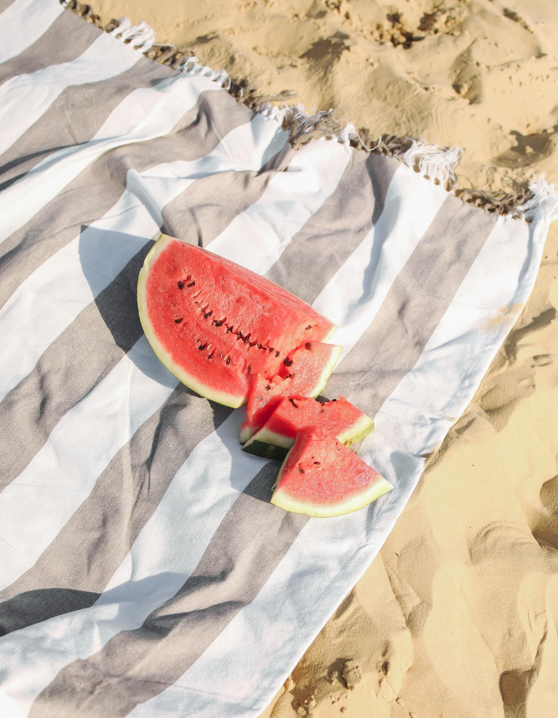 A fresh watermelon cut open, representing the health benefits of consuming seasonal produce, supporting local farmers, and reducing environmental impact through mindful food choices.